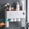 Toothpaste dispenser with toothbrush holder