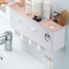 Toothpaste dispenser with toothbrush holder